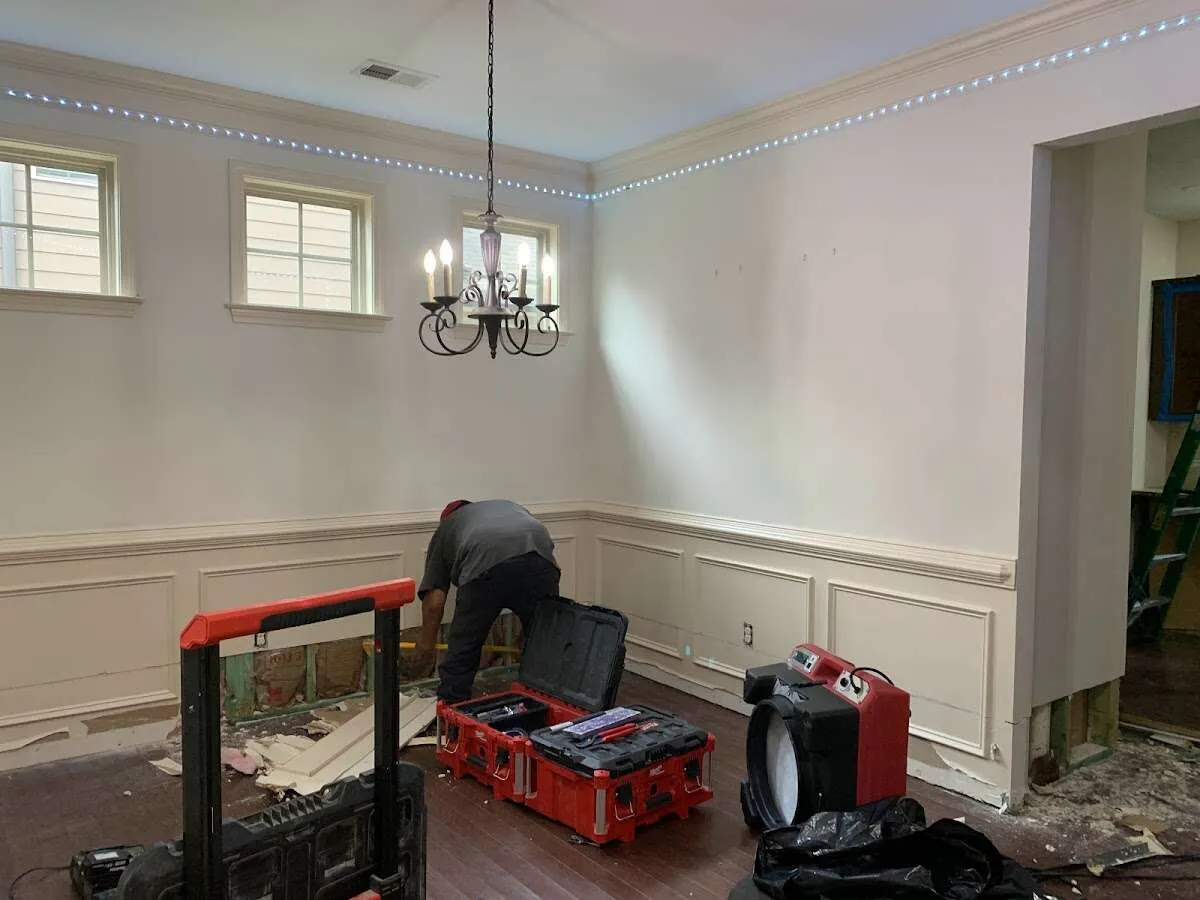 Restoration technician with professional equipment in Malverne